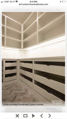 an empty room with white shelves and black stripes on the walls is featured in this instagram