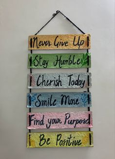 a sign hanging on the wall that says never give up stay humble cherish today smile more find your purpose be positive