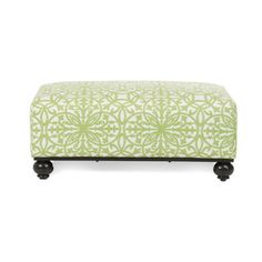 a green and white ottoman with wheels on the bottom, in front of a white background