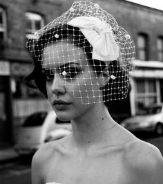 black and white photograph of woman with veil on head