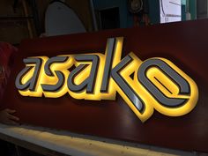 a man standing in front of a sign that says sasak on it's side