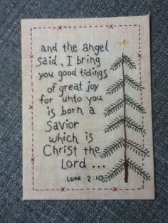 a cross stitch christmas card with the words, and an image of a pine tree