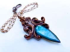 Hi Everyone, I've just finished this Neo-Baroque Pendant featuring a Floral Motif and Gem Quality Faceted Labradorite. Pendant is suspended on delicate Lozenge Link Chain accented with Fish Hook Clasp.  Pendant Height is 3 inches Chain Length is 20 inches  $127.oo + shipping Elegant Patina Necklaces As Gift, Elegant Patina Necklaces For Gifts, Elegant Bronze Jewelry With Patina, Elegant Patina Pendant Necklace, Elegant Pendant Necklace With Patina, Neo Baroque, Live Oak, Labradorite Necklace, Crystal Necklaces