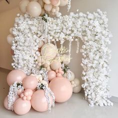 balloons and flowers are arranged in the shape of an arch