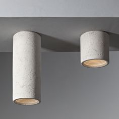 three concrete lamps hanging from the ceiling