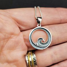 This is a very simple wave necklace. It measures 1” long from the top of the jump ring, an 3/4" wide and is solid sterling silver. Named for the Lapakahi State Park in Hawaii it reminds us of warm, salty winds and afternoons in the sun. Hypoallergenic Spiral Sterling Silver Jewelry, Spiral Sterling Silver Jewelry With Oxidized Finish, Everyday Silver Jewelry With Wavy Design, Everyday Silver Jewelry With Wavy Shape, Everyday Silver Wavy Jewelry, Adjustable Wavy Sterling Silver Jewelry, Handmade Silver Wavy Jewelry, Sterling Silver Wavy Necklace For Gifts, Silver Wavy Necklace For Gift