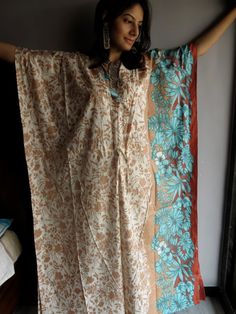 "I made this Kaftan from a beautiful Cream with Brown and blue 100% mulmul cotton. But I have the same fabric available in many other colors so during checkout just choose the color you want this robe in. The color swatches are shown in the last pic. If you want the same one as pictured, just select the \"Same as Picture\" option in the \"colors\" variation during checkout. Mulmul is a very fine variety of cotton which is extremely soft and it gets softer with every wash. It is so free flowing, Bohemian Style Cream Kaftan For Beach, Bohemian Cream Kaftan For Vacation, Bohemian Cream Kaftan For The Beach, Bohemian Beige Kaftan For Wedding, Traditional Long Robe For The Beach, Traditional Beach Maxi Dress For Festivals, Summer Festive Floor-length Kaftan, Traditional White Dresses For Beach Season, White Festive Maxi Dress For Beach