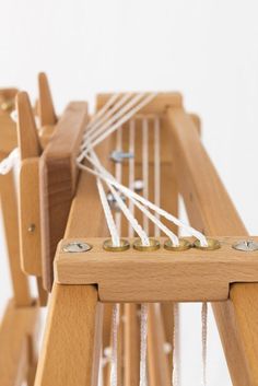 a close up of a wooden structure with strings on it