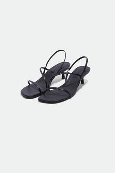 PRE-FALL 2024 WOMEN'S COLLECTION The Cedonia Sandal in Black. Featuring sleek straps and a comfortable kitten heel, these sandals are perfect for both casual and dressy occasions.