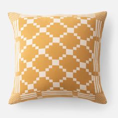 an orange and white checkered pillow with polka dots