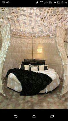 a bed that is made up with black and white decor on it's sides