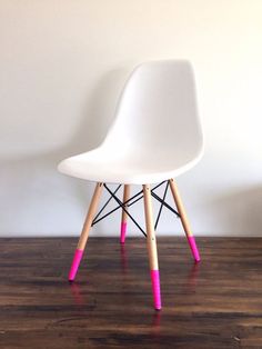 a white chair sitting on top of a hard wood floor