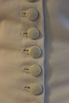 buttons on the back of a white shirt