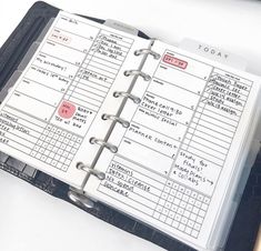 an open planner book sitting on top of a desk