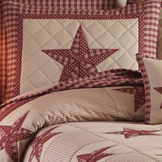 a red and white quilted bed with stars on it