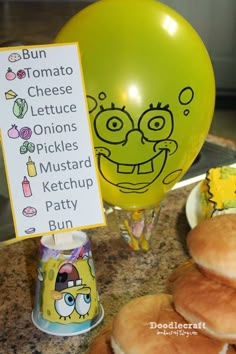 a table topped with hamburgers and balloons