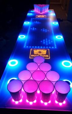 an illuminated table with cups and neon lights