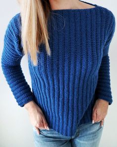 a woman wearing a blue sweater and jeans