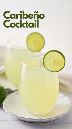 two glasses filled with white liquid and limes