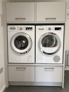 two washers are sitting side by side in front of each other