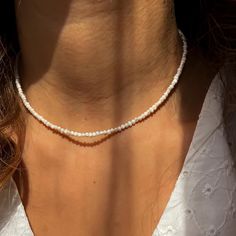 This delicate necklace is crafted with 2-3mm natural freshwater pearls for a minimalist and elegant look. Perfect for everyday wear or special occasions, the pearls radiate timeless beauty.  The necklace is designed with durable stainless steel findings and chain, ensuring it's resistant to tarnishing and suitable for long-term use. The adjustable chain allows for a customized fit, making it an ideal gift for anyone who loves dainty and sophisticated jewelry. Whether you're looking for a stylish Minimalist Pearl White Beaded Necklaces With Pearl Charm, Minimalist Everyday Beaded Necklace With Pearl Drop, Minimalist Pearl Beaded Necklaces For Everyday, Minimalist Pearl White Beaded Necklace With Pearl Charm, Minimalist Pearl Beaded Necklace For Everyday, Minimalist Pearl Necklace With Tiny Beads, Minimalist Pearl White Necklace With Tiny Beads, Minimalist Pearl White Pearl Necklace With Tiny Beads, Minimalist Pearl Beaded Necklaces With Tiny Beads