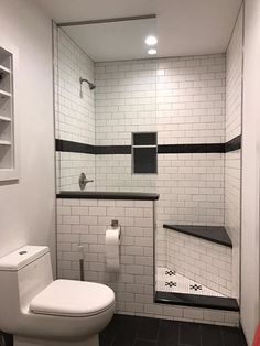 a white toilet sitting next to a walk in shower