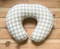 a white and grey checkered pillow on wooden floor