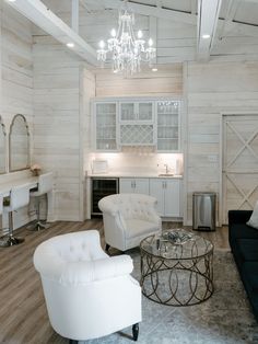 a living room filled with furniture and a chandelier