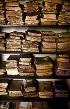 several shelves filled with old books and papers