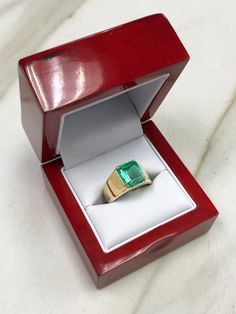 an open red box with a ring in it