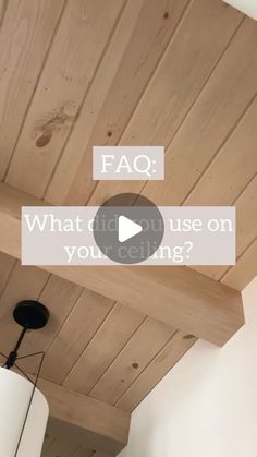 the ceiling is made out of wood and has a light fixture hanging from it's side