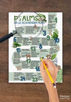 a person is holding a pencil and looking at a calendar with palm leaves on it