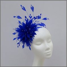 Stunning cobalt blue full feather fascinator/headpiece. Designed with different cut feathers and delicate blue pearl sprays to give this design a real unique look. Made on a headband. This design is available in other colours on request. All of our designs can be made to order in a range of Silver Fascinator, Royal Blue Fascinator, Grey Fascinator, Navy Blue Fascinator, Navy Fascinator, White Fascinator, Floral Fascinators, Black And White Hats, Bespoke Hats