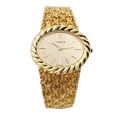 Ladies Corum 26mm x 30mm Oval Vintage 18K Yellow Gold Watch with Gold Dial and Weave Bezel. Pre-Owned SN# 163**** Brand: Corum. Dial Color: Gold. Type: Wristwatch. Gender: Women's. Condition: Excellent. Bezel: 18K Yellow Gold. Total Weight: 62 Grams. Case Size: 26mm x 30mm. Movement: Quartz (Battery). Band Material: 18K Yellow Gold. Bezel Material: 18K Yellow Gold. Bracelet Size: Fits 6.5" to 6.75" Wrist. Warranty: One (1) Year Limited Service Warranty. Luxury Gold Oval Watch, Luxury Oval Gold Watches, Yellow Gold Oval Watch For Gift, Oval Yellow Gold Watch As Gift, Oval Yellow Gold Watches For Gifts, Gold Oval Watch With Diamond Hour Markers, Gold Oval Watches With Diamond Hour Markers, Gold Oval Watches For Anniversary, Corum Watches