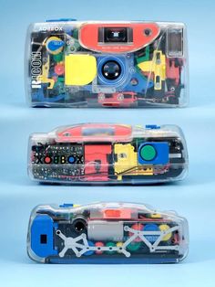 two plastic cases with different types of toy cars in them on a blue background, one is open and the other has an electronic device attached to it's side