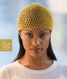 a woman wearing a yellow crochet hat