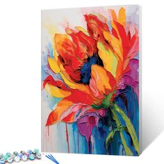 a large colorful flower painting on a white wall next to beaded bracelets and beads