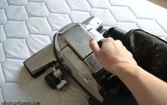 a person is pressing the button on a mattress that has been made into a machine