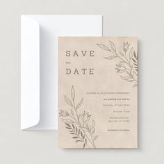 an elegant save the date card with leaves and flowers on it is displayed next to a white envelope