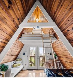 a loft with wood paneling and a ladder to the ceiling, in front of a white door