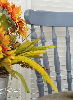 a blue chair with yellow flowers in it