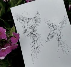 two drawings of birds on paper next to purple flowers