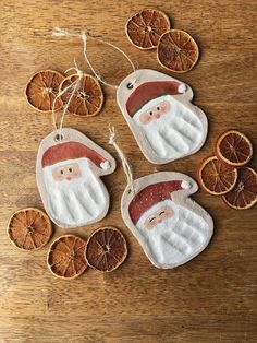 orange slices and santa clause ornaments on a wooden table