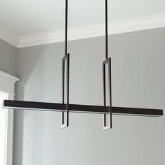 three rectangular lights hanging from a ceiling fixture in a room with gray walls and white trim