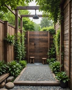 an outdoor shower surrounded by plants and rocks