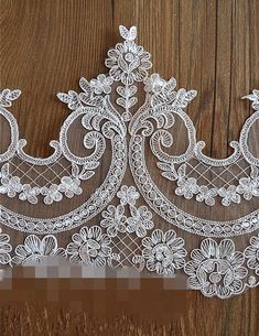 a white lace piece on a wooden surface