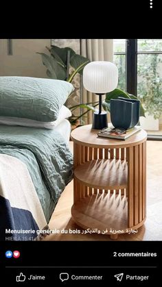 a bed room with a neatly made bed and a night stand on the end table