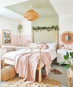 a bedroom with pink walls and white bedding, wicker baskets on the floor