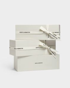 three white boxes with ribbons tied around them