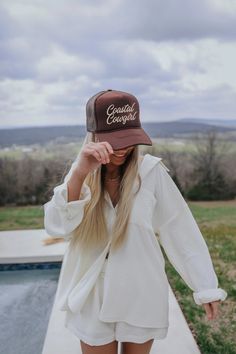 Coastal Cowgirl Trucker Hat - Brown Every proper coastal cowgirl needs a trucker that says so. Replace your cowboy hat with this trucker riding horses on the coastline! This chocolate brown hat with tan embroidery is the perfect, neutral accessory for your wardrobe while you ride the waves! Chocolate brown trucker hat Tan "Coastal Cowgirl" embroidery Adjustable trucker hat Brown Curved Bill Trucker Hat For Summer, Brown Summer Trucker Hat With Curved Bill, Brown Snapback Trucker Hat For Spring, Casual Brown Baseball Cap For Rodeo, Brown Spring Trucker Hat, Brown Country Style Baseball Cap With Curved Brim, Brown Summer Baseball Cap, Brown Trucker Hat For Spring, Brown Trucker Hat Baseball Cap For Spring